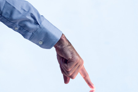 Man pointing on reflective surface in close upの写真素材
