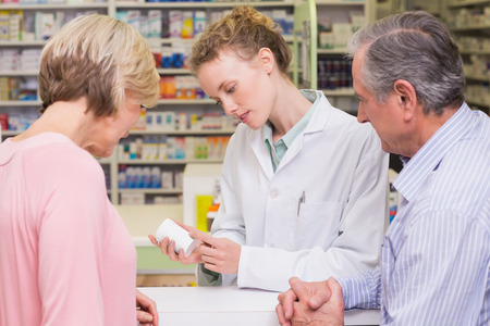 Pharmacist and sick customer speaking in the pharmacyの写真素材