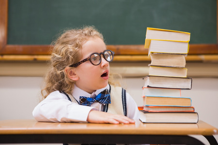 Surprise pupil looking at books at elementary schoolの写真素材