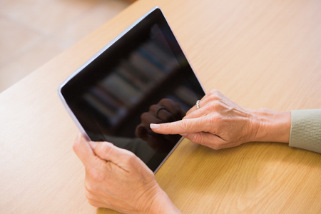 Teacher using tablet pc at her deskの写真素材