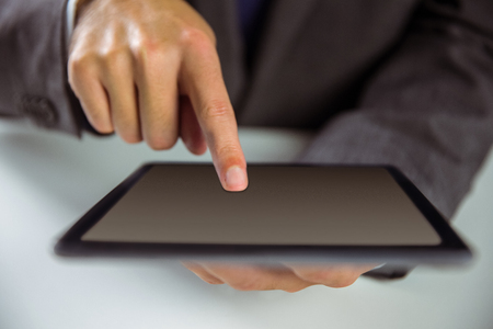 Businessman using his tablet pc in close upの写真素材