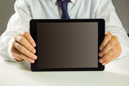 Businessman showing his tablet pc in close up