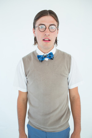 Geeky hipster looking at camera on white backgroundの写真素材
