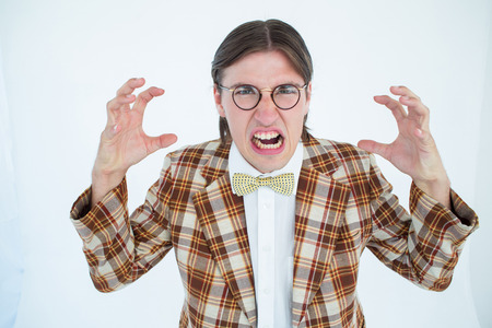 Furious geeky hipster looking at camera on white backgroundの写真素材
