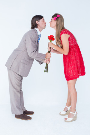 Cute geeky couple kissing on white backgroundの写真素材