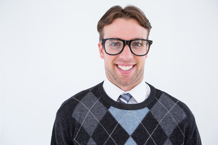 Geeky hipster smiling at camera on white backgroundの写真素材