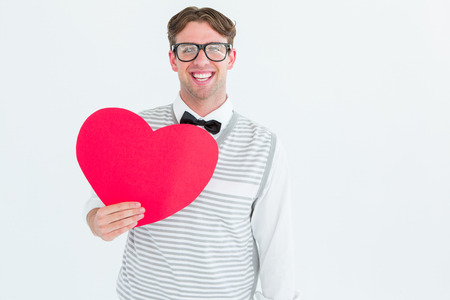 Geeky hipster holding heart card on white backgroundの写真素材