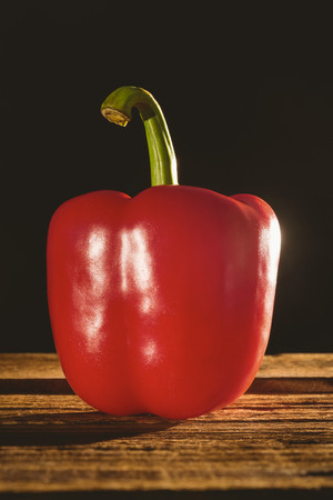 Red pepper on chopping board with copy spaceの写真素材