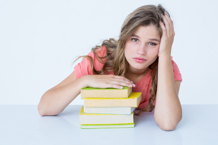Tired hipster lying on table on white backgroundの写真素材