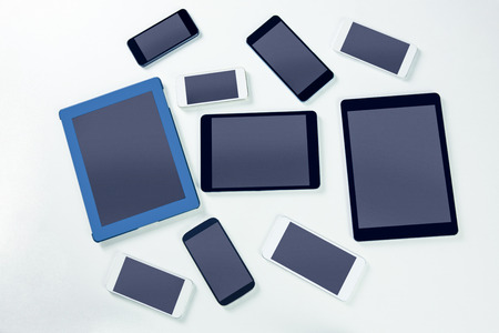 Overhead of smartphones and tablets on white backgroundの写真素材