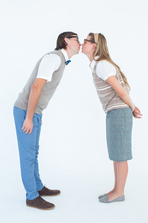 Geeky hipster couple kissing on white backgroundの写真素材