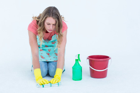 Woman cleaning the floor on white backgroundの写真素材