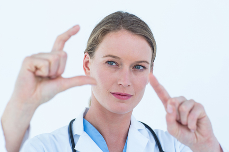 Doctor showing with finger on white backgroundの写真素材