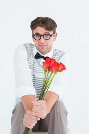 Geeky hipster offering bunch of roses on white backgroundの写真素材