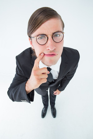 Thoughtful geeky businessman on white backgroundの写真素材