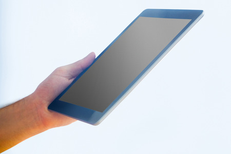 Hand holding a tablet pc in close upの写真素材