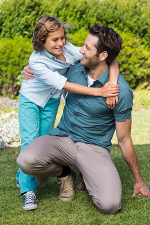 Father and son smiling at each other in the countrysideの写真素材