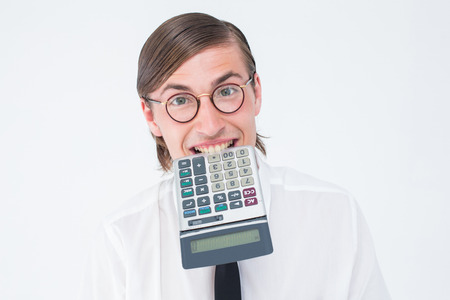 Geeky smiling businessman biting calculator on white backgroundの写真素材