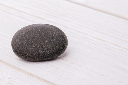 Pebble on a wooden table shot in studio