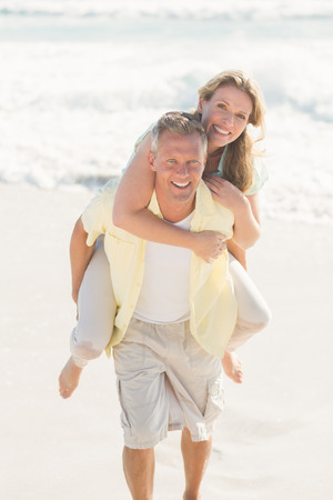 Happy couple having fun together at the beachの写真素材
