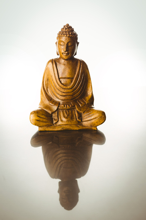 Wooden buddha statue shot in studioの写真素材