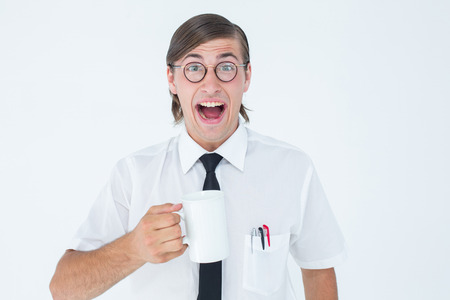 Geeky businessman holding a mug on white backgroundの写真素材