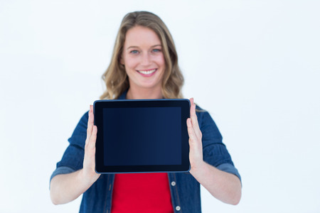 Smiling woman holding tablet pc on white backgroundの写真素材