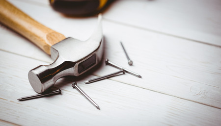 Hammer and nails laid out on table shot in studio