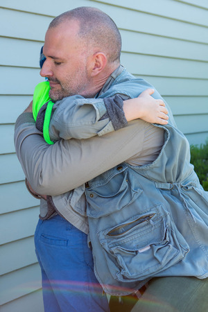 Father and son hugging in the countrysideの写真素材