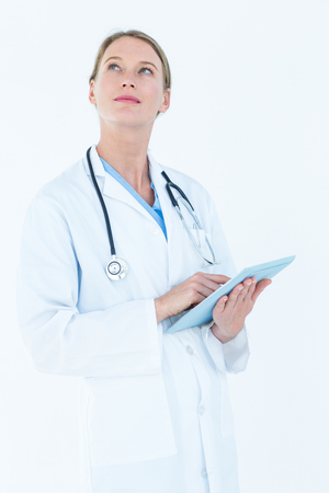 Doctor using tablet pc on white backgroundの写真素材