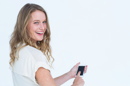 Woman using smartphone on white backgroundの写真素材