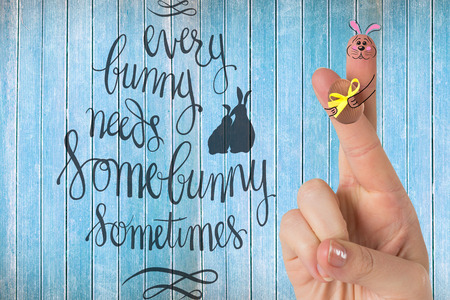 Fingers as easter bunny against wooden planksの写真素材