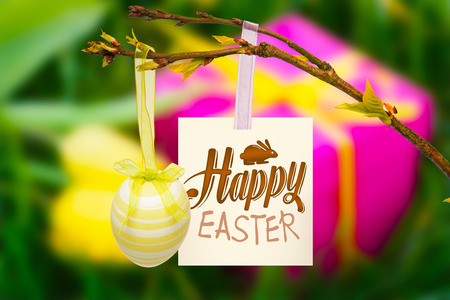 happy easter graphic against pink gift box and yellow tulips
