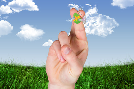 Fingers as easter bunny against blue skyの写真素材