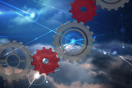 Cogs and wheels against lines against glowing sky