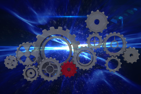 Cogs and wheels against blue abstract designの写真素材
