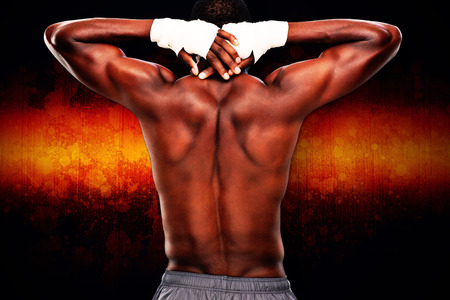 Muscular man against dark backgroundの写真素材