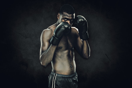 Muscular boxer against dark backgroundの写真素材