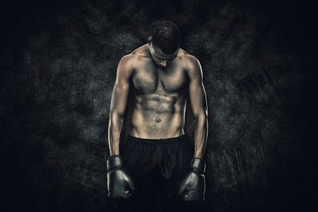 Muscular boxer against dark backgroundの写真素材