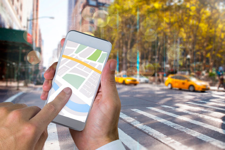 Man using map app on phone against blurry new york street