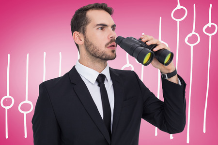 Surprised businessman standing and holding binoculars  against pink vignetteの写真素材