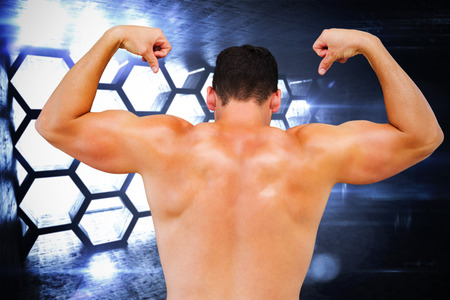 Attractive bodybuilder against hexagon roomの写真素材