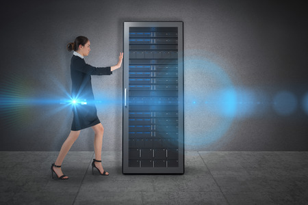 Businesswoman pushing against grey room