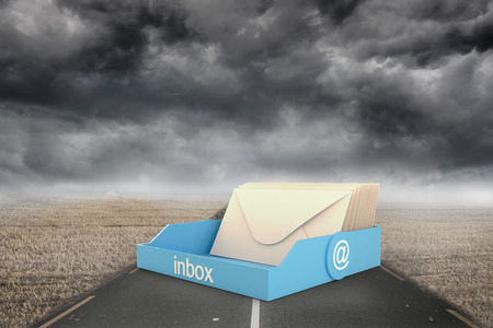 Blue inbox against misty brown landscape with streetの写真素材