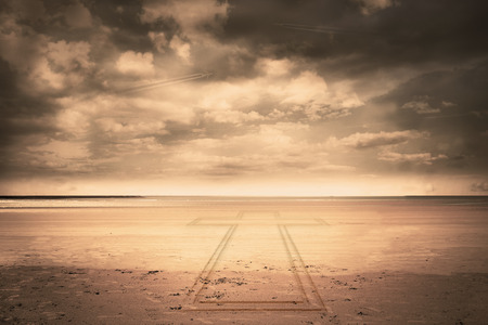 Cross against serene beach landscapeの写真素材