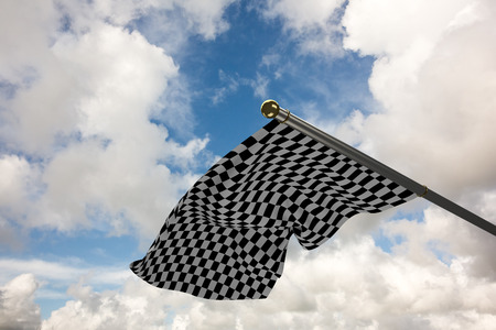 Checkered flag against blue sky with white cloudsの写真素材