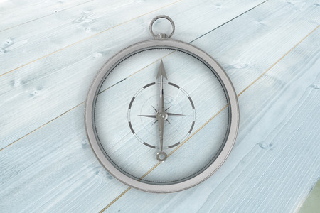 Compass against bleached wooden planks backgroundの写真素材