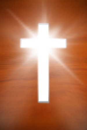 white cross against wooden oak tableの写真素材