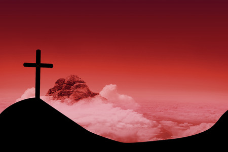 Wooden cross against sky and mountainsの写真素材