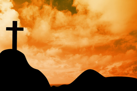 Wooden cross against sky and mountainsの写真素材
